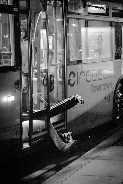 A couple jumps into the rear doors of the Circulator bus as the doors closes... they didn't quite make it.